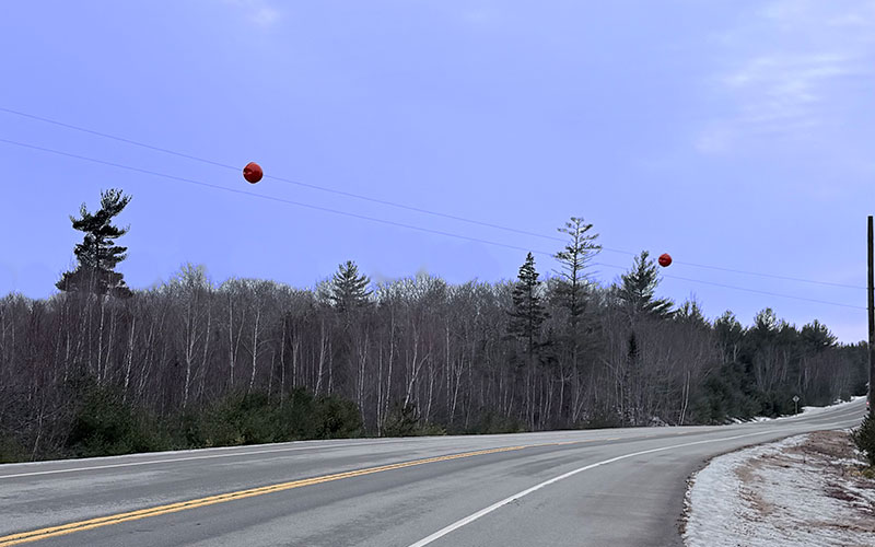 Serial marker balls installed on overhead lines near Wesley, Maine, to improve EMS helicopter safety.